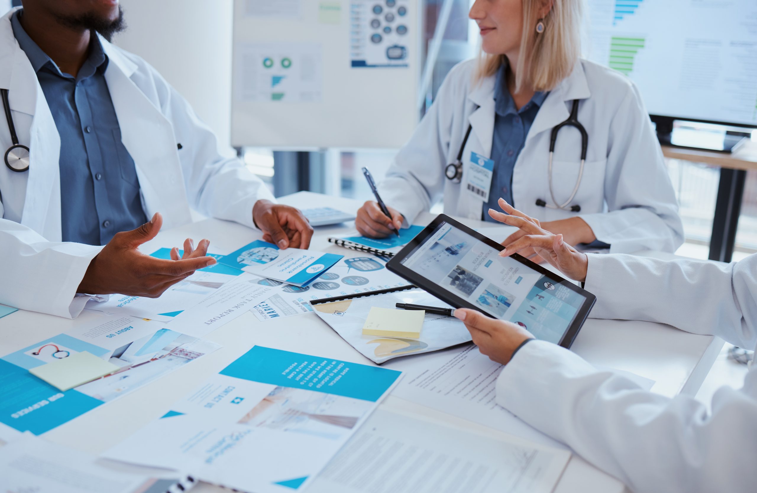 Healthcare doctors and meeting documents with tablet data for business discussion in office. Medical paperwork communication and analytics improvement for development of medicare company